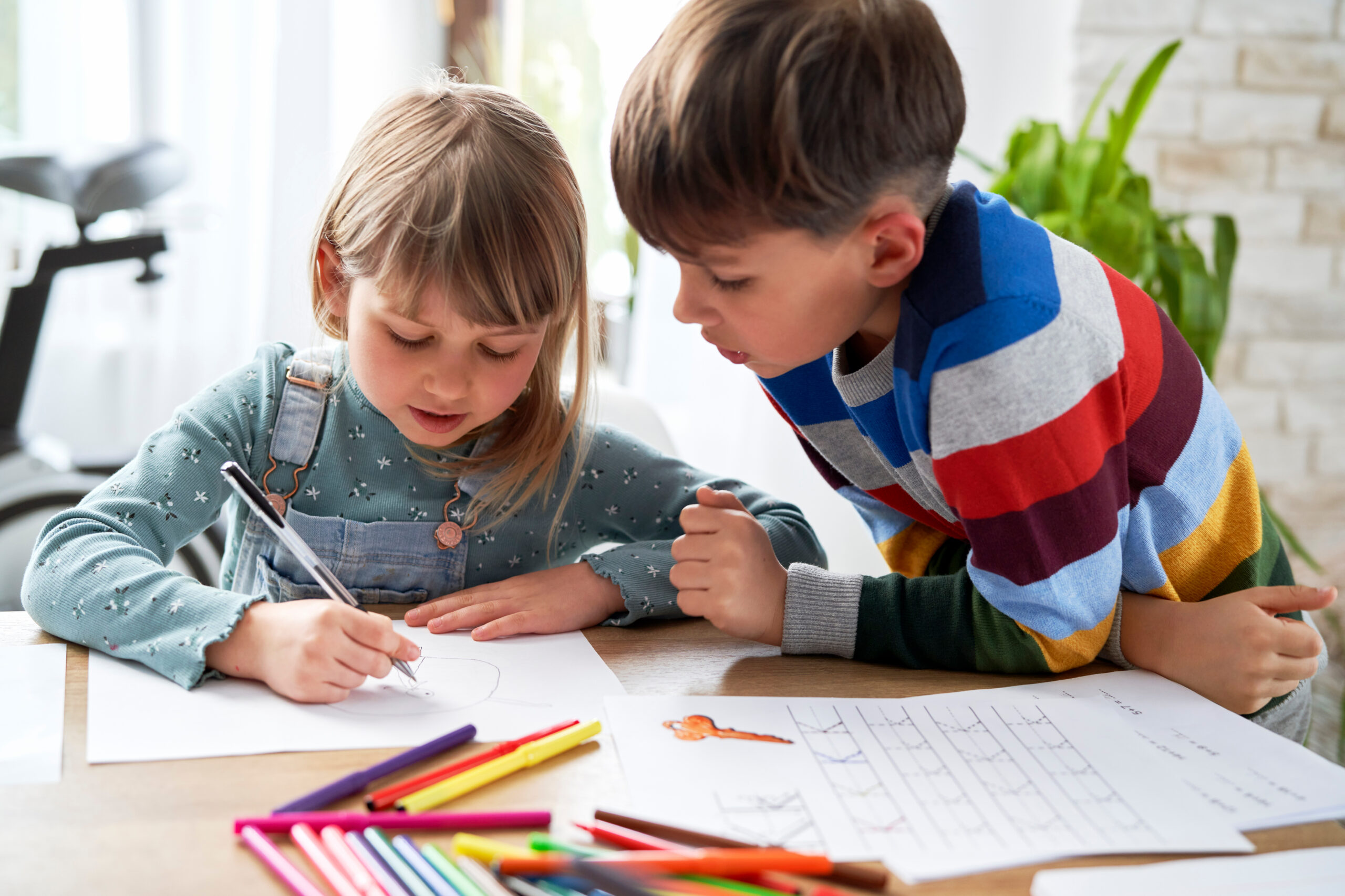 Big brother helping his sister with her homework